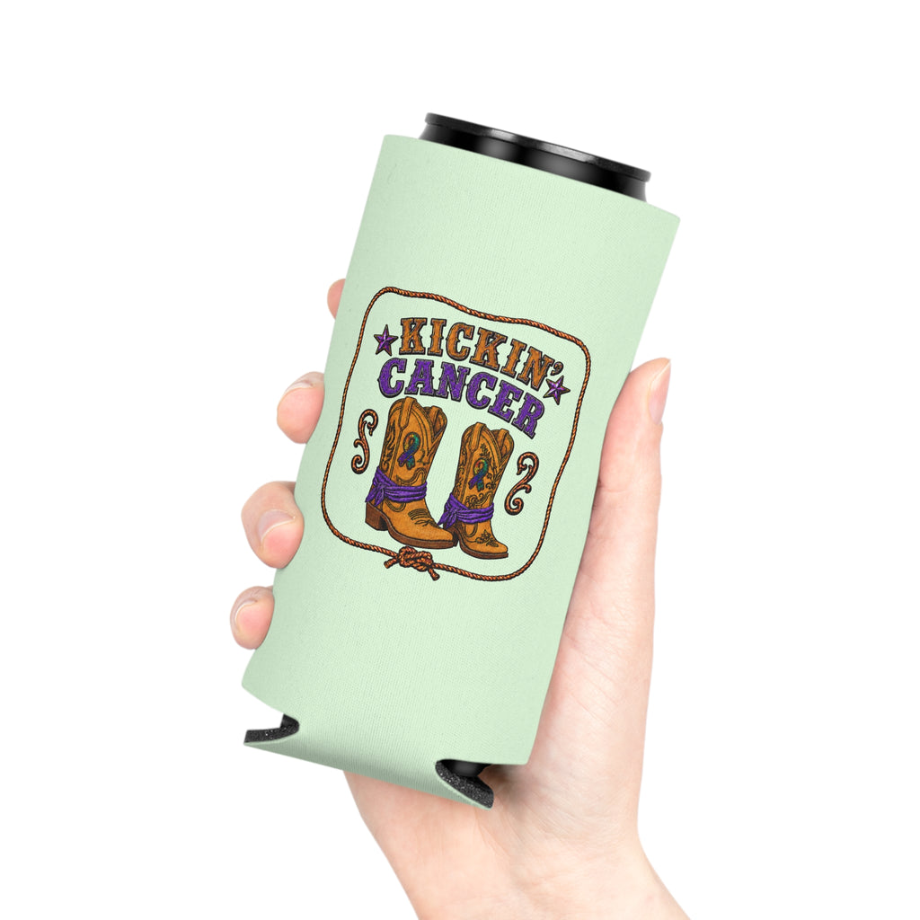 Hand holding a Kickin’ Cancer light green slim can cooler with western boot and awareness-ribbon artwork.