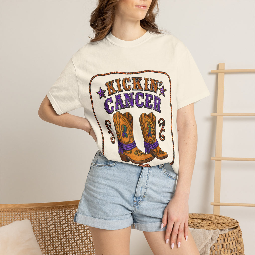 Woman wearing a cream Kickin' Cancer T-shirt with cowboy boot front artwork
