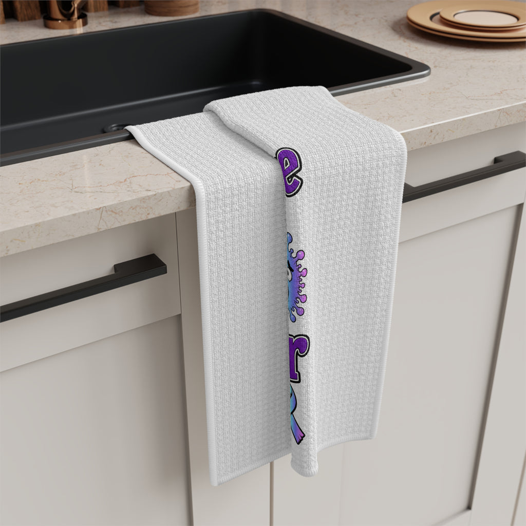 Moooove Over Cancer microfiber tea towel draped over a counter with colorful artwork