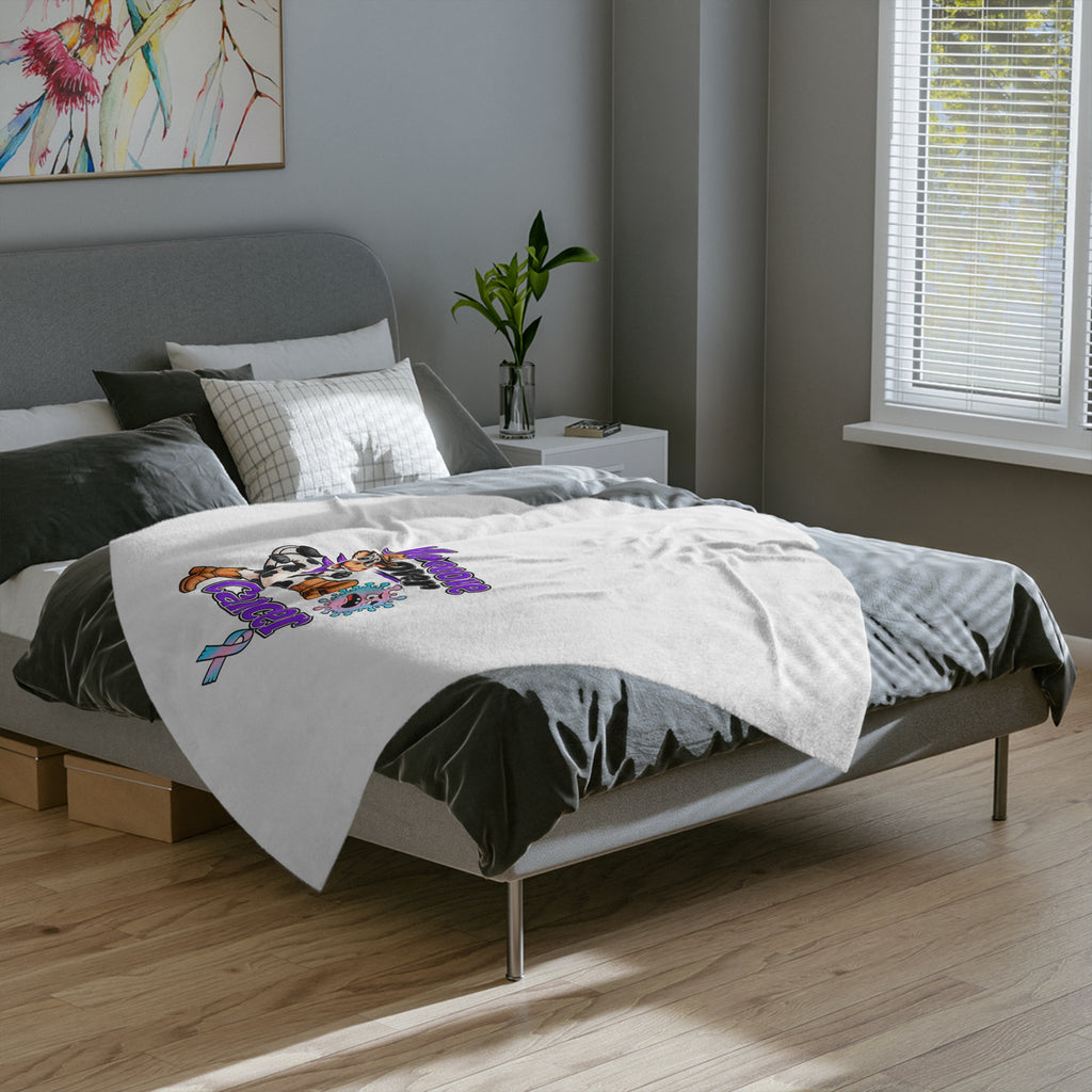 Moooove Over Cancer microfiber blanket spread across a bed
