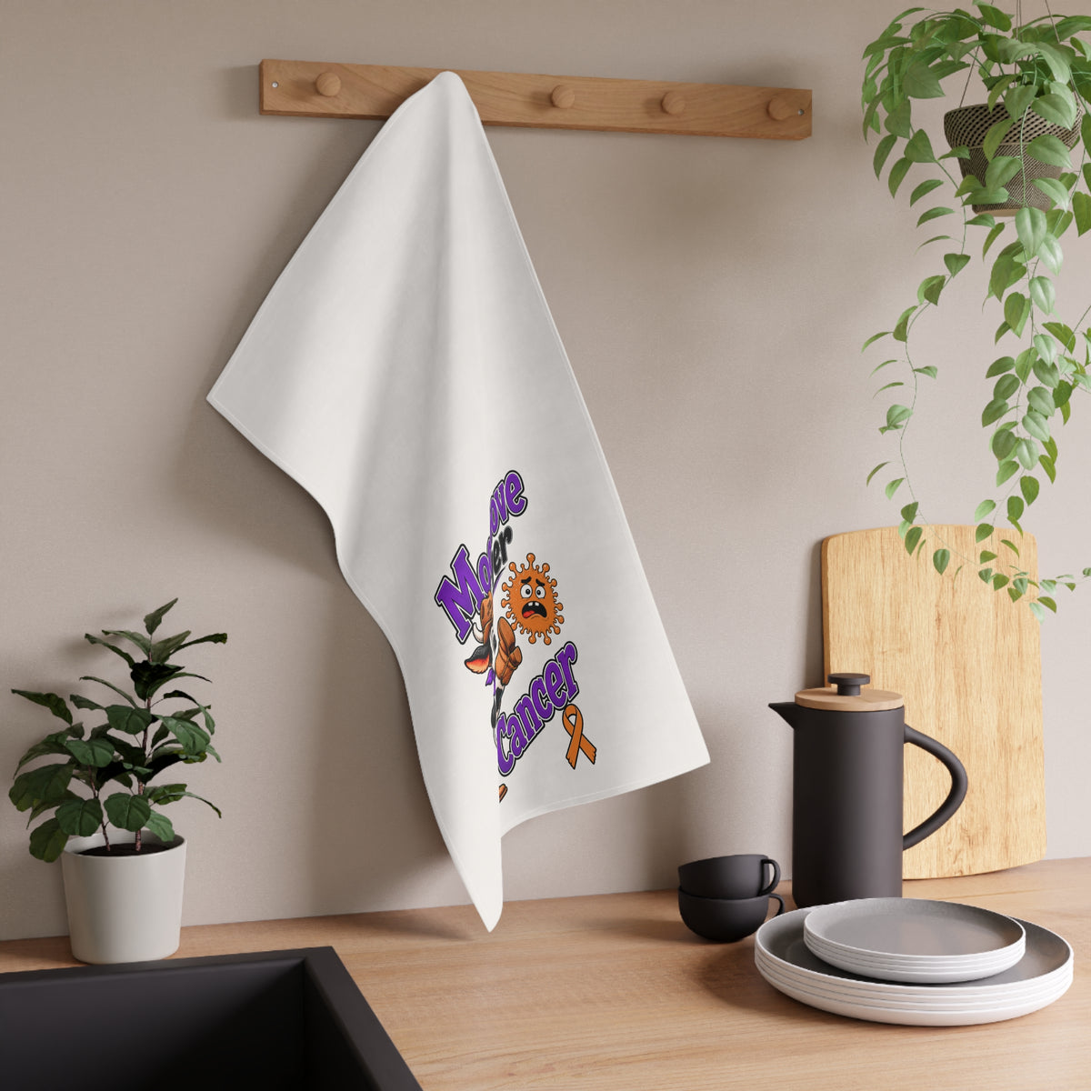 Moooove Over Cancer tea towel hanging in a kitchen with colorful cow artwork