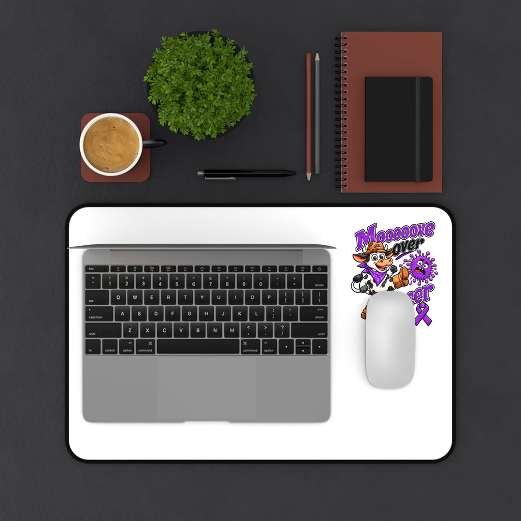 Moooove Over Cancer desk mat with laptop and mouse on a white surface