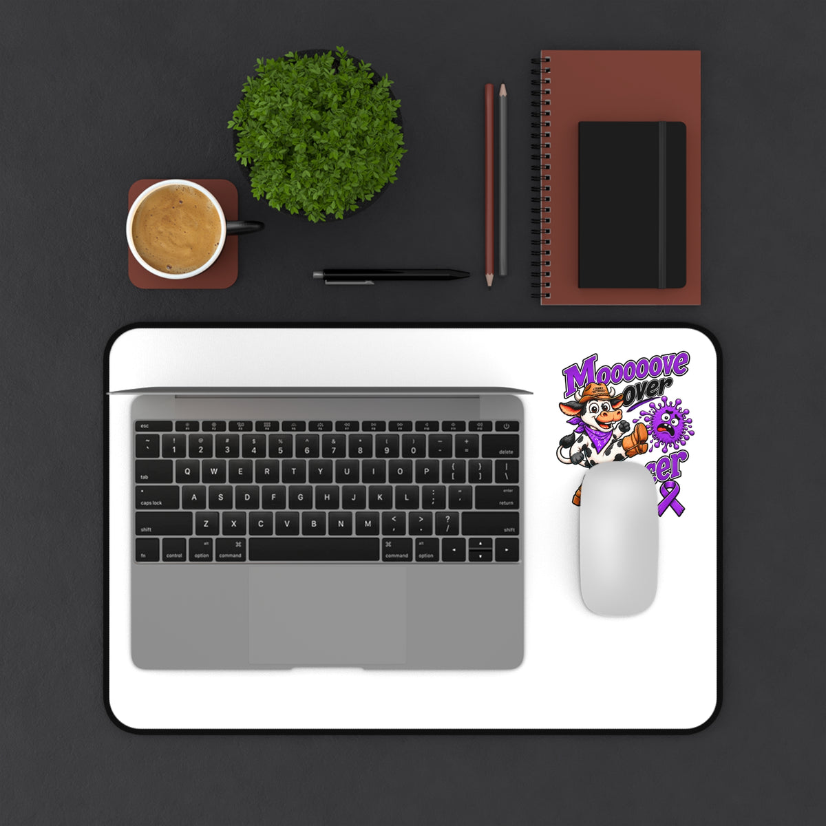 Moooove Over Cancer desk mat with laptop and mouse on a white surface