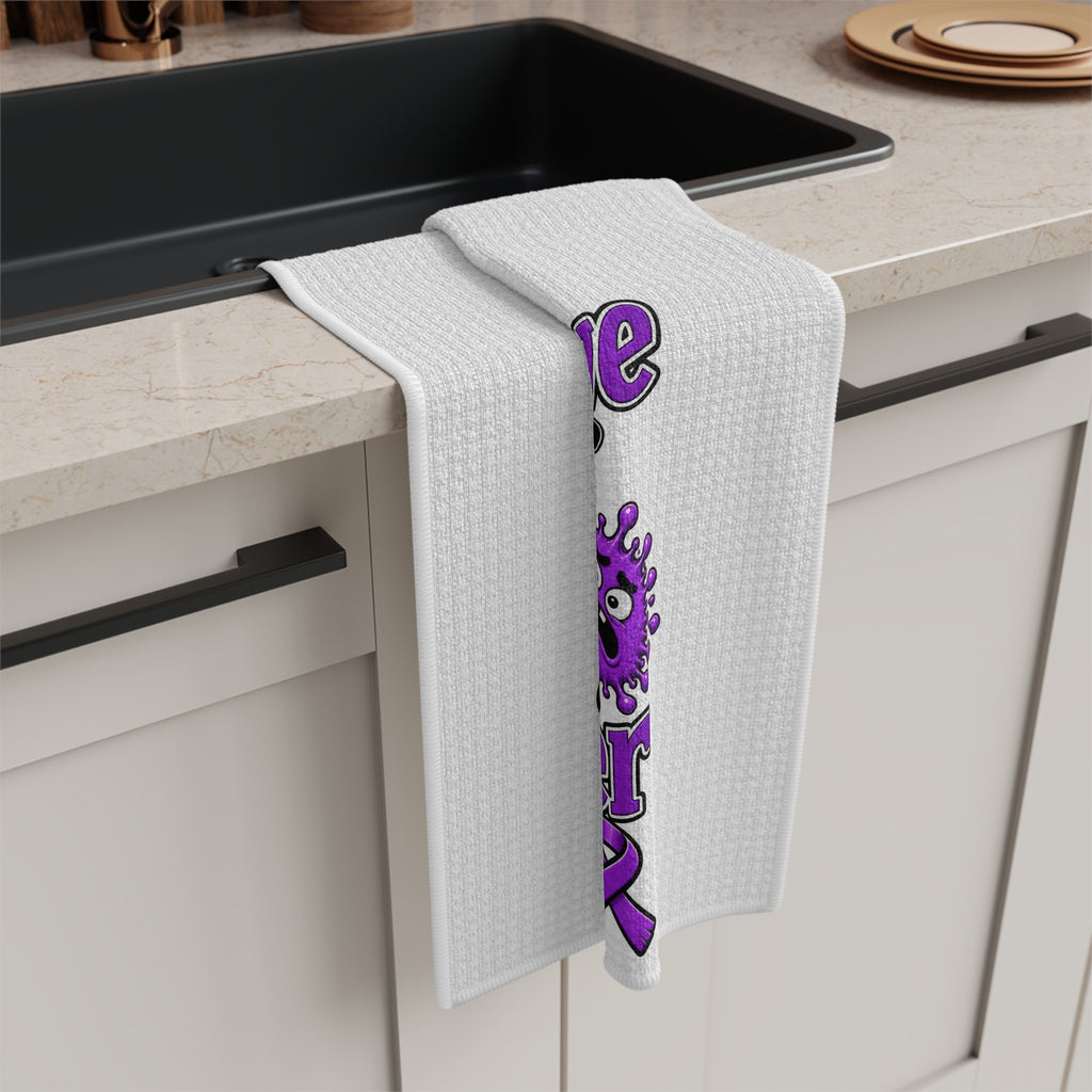 Moooove Over Cancer tea towel draped over a counter with cow and purple ribbon artwork