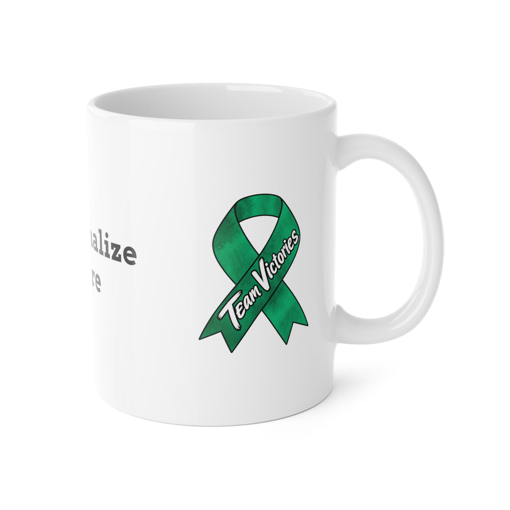 Moooove Over Cancer mug showing green Team Victories awareness ribbon and white ceramic finish