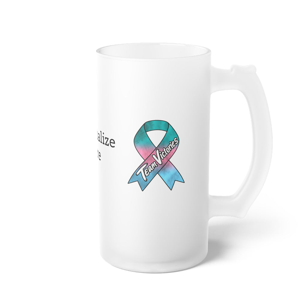 Team Victories ribbon artwork on the side of a Moooove Over Cancer glass mug