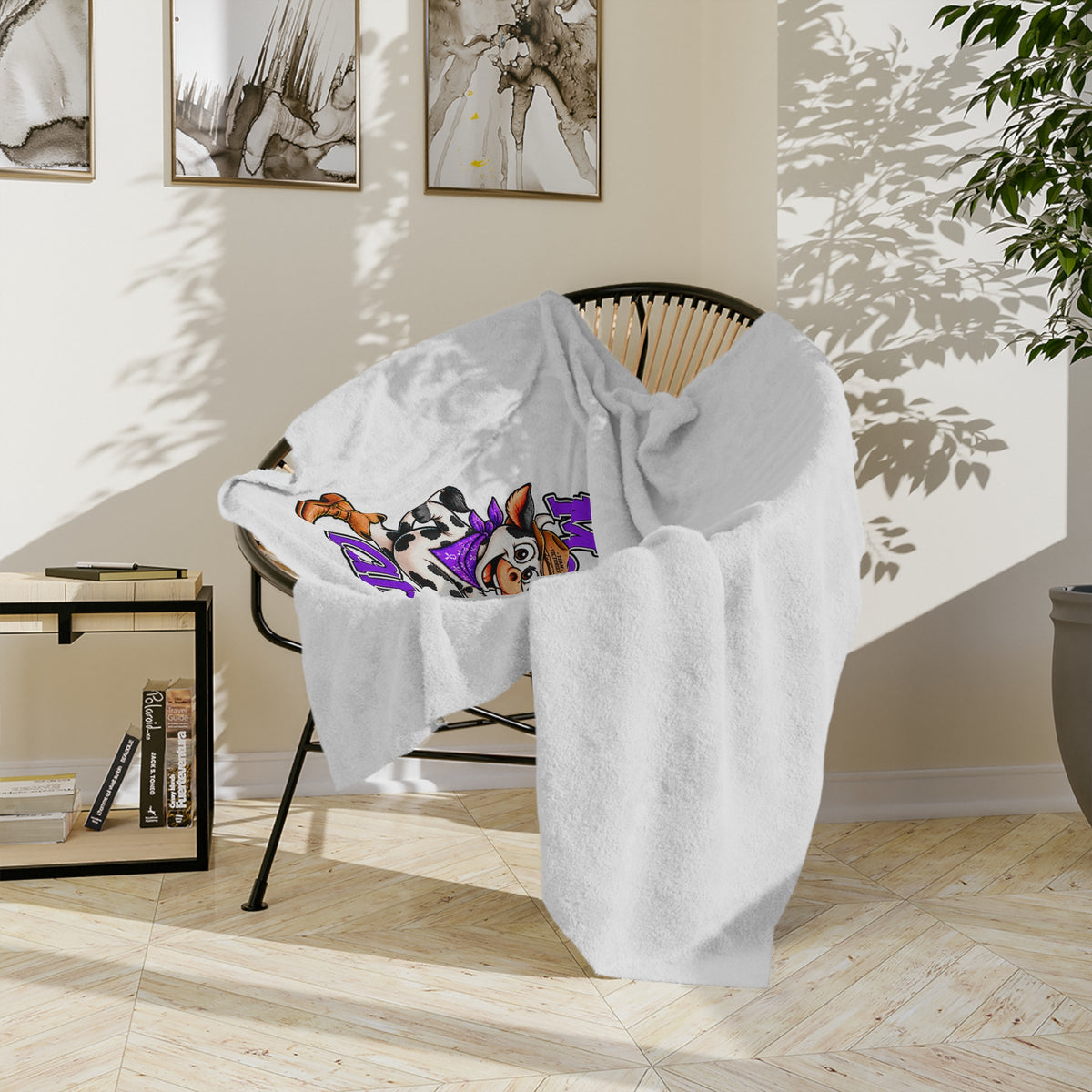 Close view of the Moooove Over Cancer blanket draped over a chair