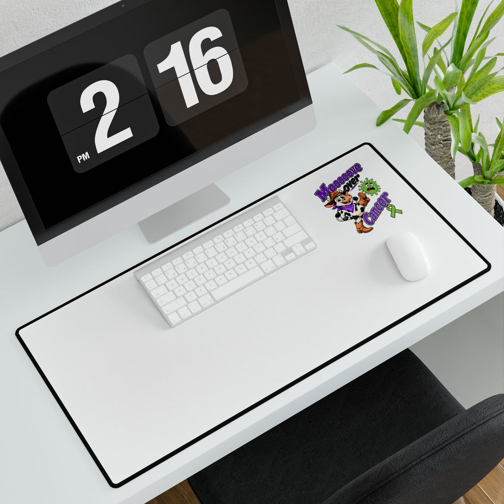 Moooove Over Cancer desk mat arranged with a keyboard and mouse on a white desk