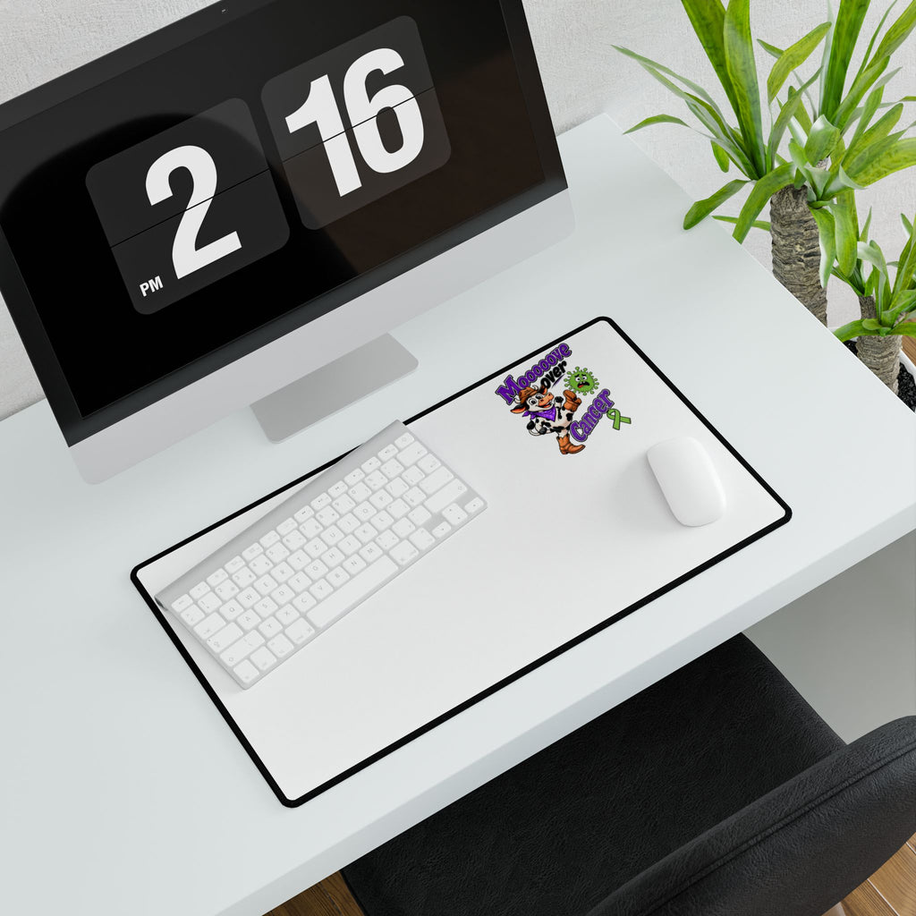Overhead view of Moooove Over Cancer desk mat with colorful awareness artwork