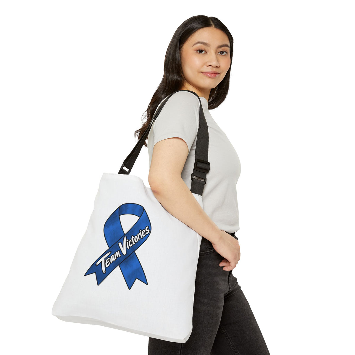 Model carrying the Team Victories blue ribbon shoulder tote