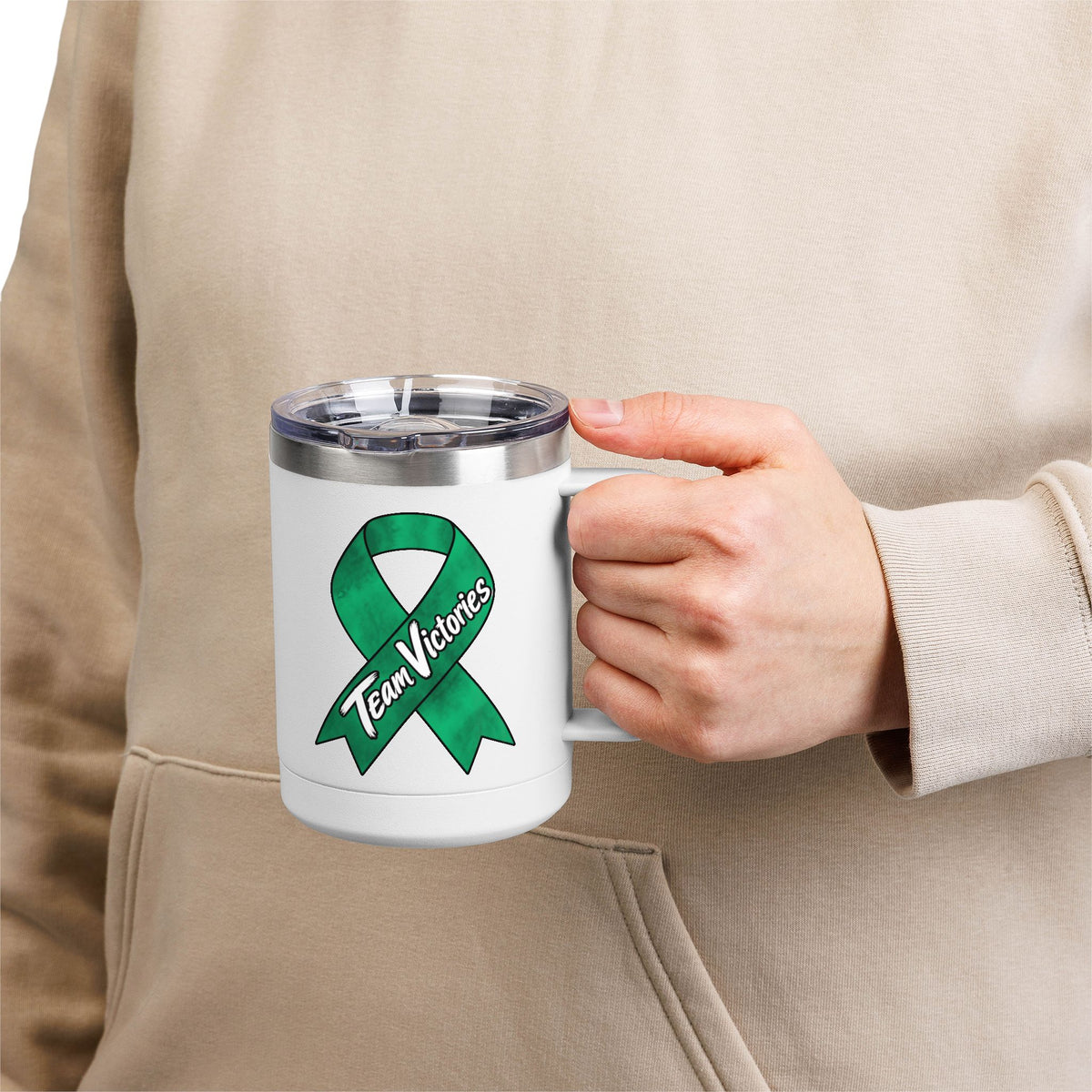 Person holding white Team Victories mug with green Liver Cancer awareness ribbon