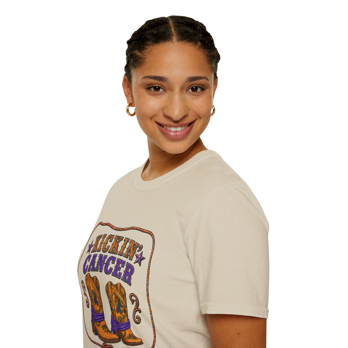 Model wearing the sand-colored Kickin' Cancer T-shirt with Western boot graphic