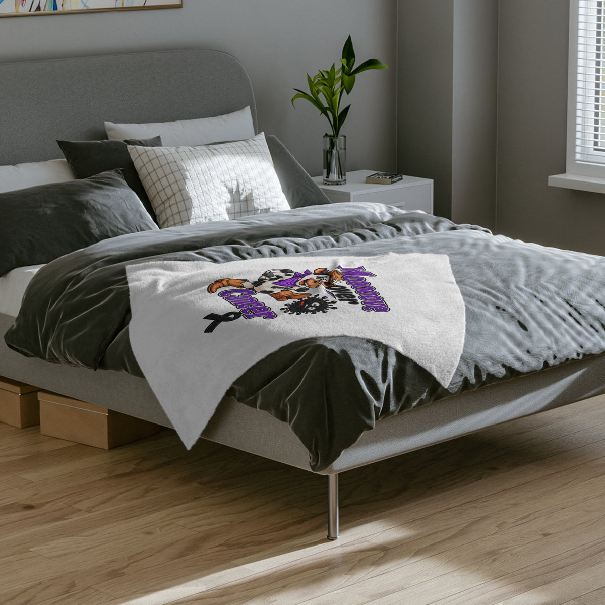 Moooove Over Cancer velveteen blanket displayed across a bed