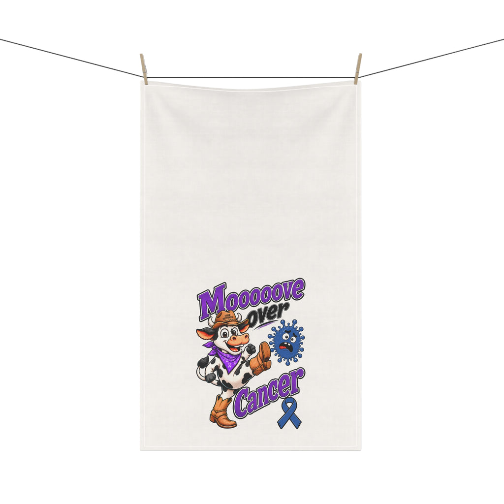 Moooove Over Cancer tea towel hanging on a clothesline with cow design visible