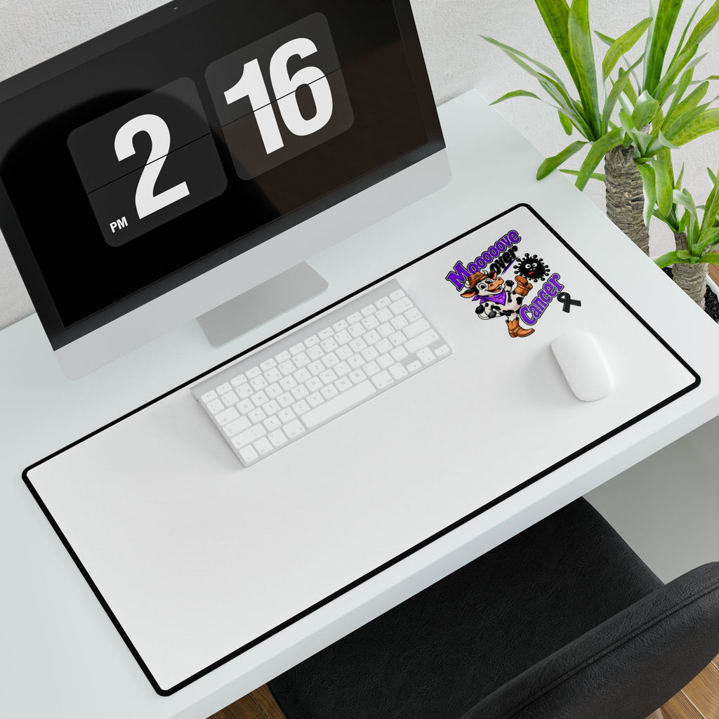 Moooove Over Cancer desk mat displayed on a computer desk with keyboard and mouse