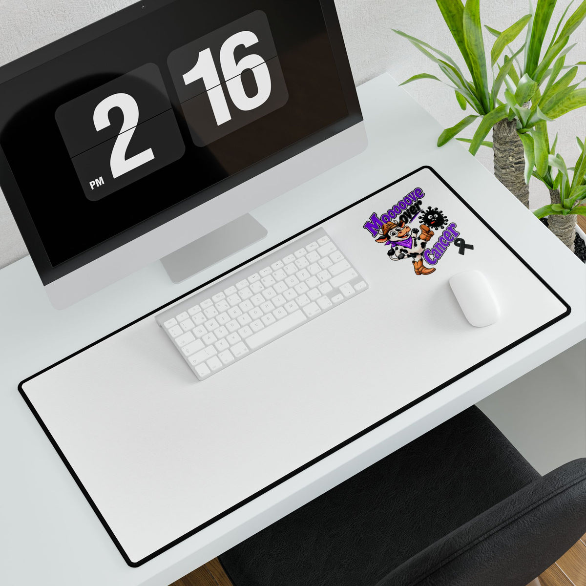 Moooove Over Cancer desk mat displayed on a computer desk with keyboard and mouse