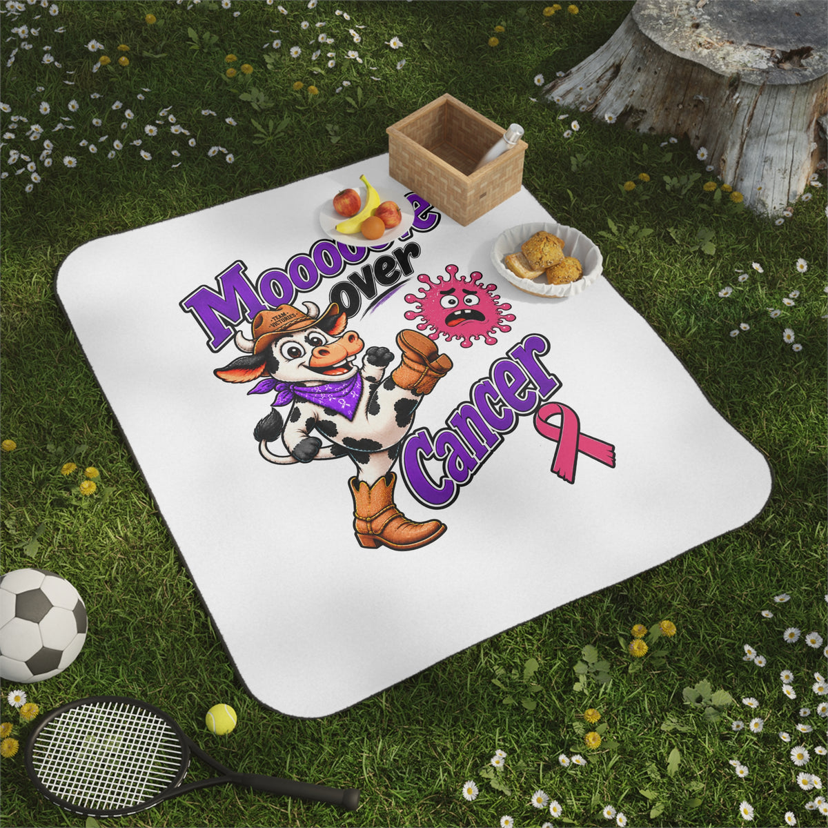 Moooove Over Cancer picnic blanket with cow design spread on grass