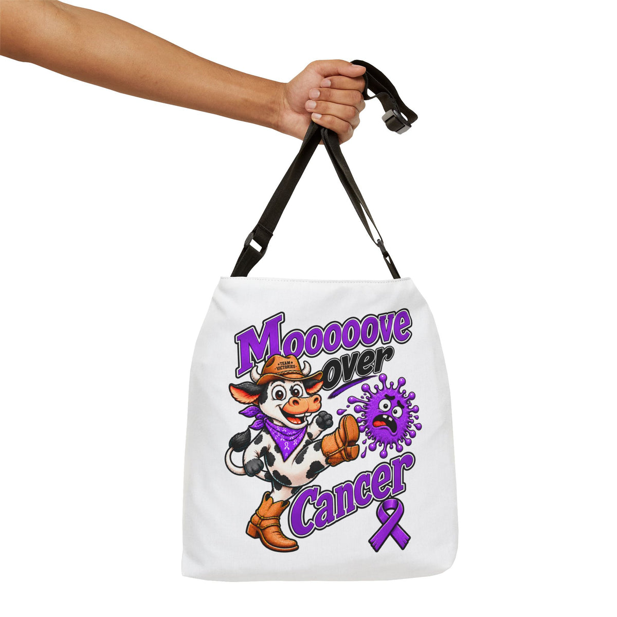 Moooove Over Cancer shoulder tote held by hand, showing the printed front